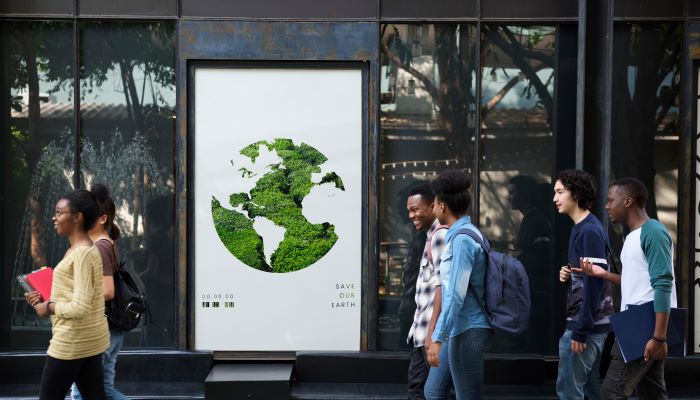 Students walking by an Ad poster